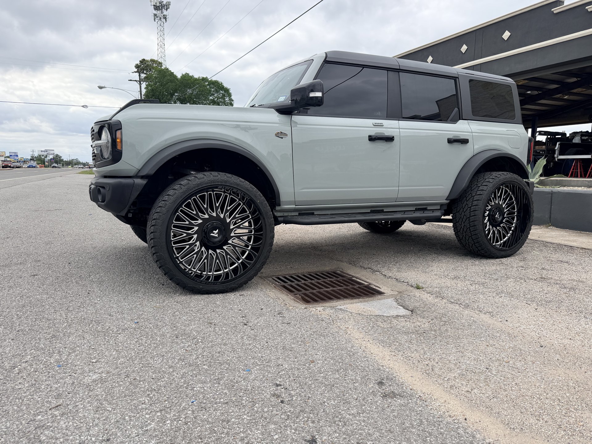 Sage green Ford Bronco with suspension lift and black spoked wheels, Level Up Customs, Alvin TX
