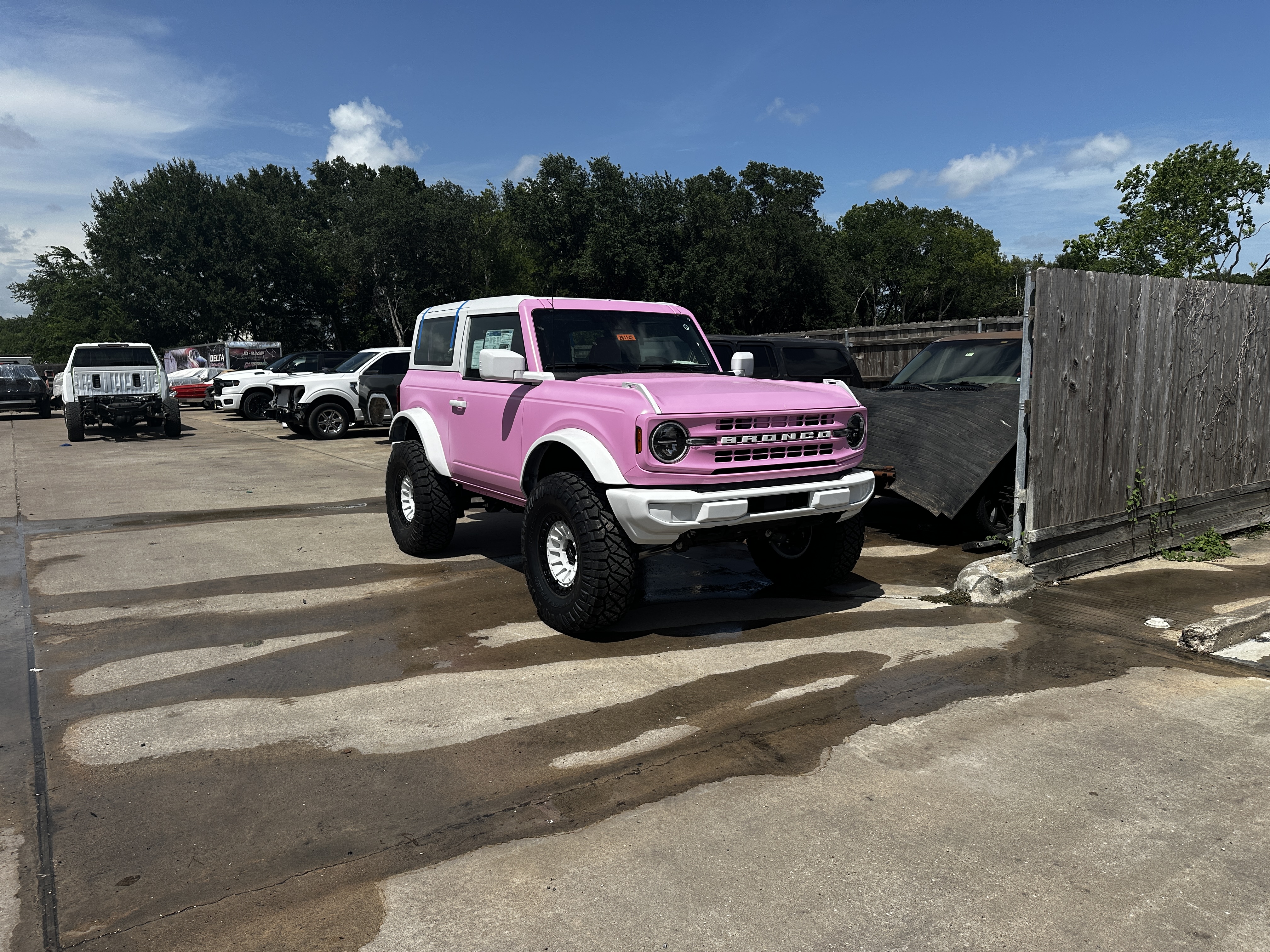 Pink and white lifted Ford Bronco with custom color wrap, Level Up Customs, Alvin TX