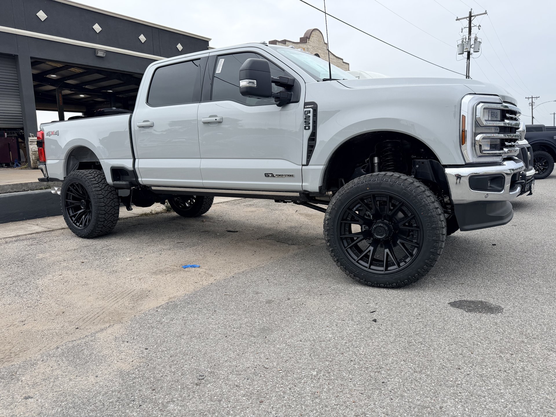 Lifted Ford F-250 Lariat with black custom wheels, Level Up Customs, Alvin TX