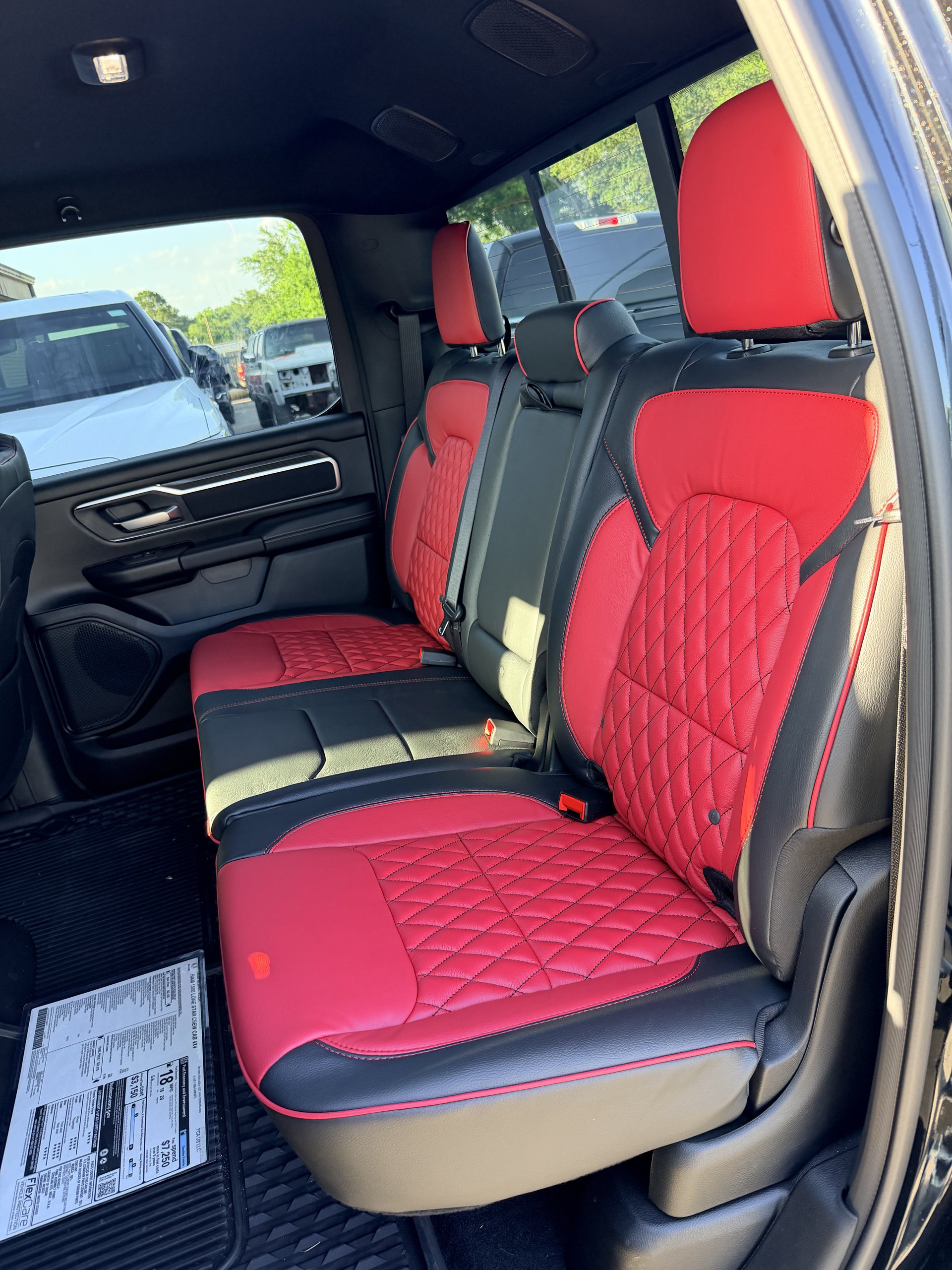 RAM truck with red and black diamond-stitch leather rear seats, Level Up Customs, Alvin TX